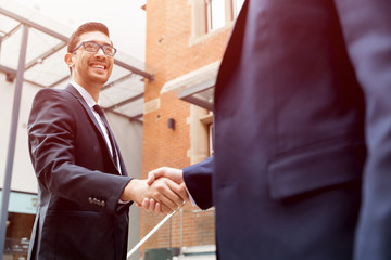 Two businessmen shaking their hands