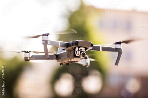 Fotografie, Obraz drone quad copter with high resolution digital camera flying hovering in the blu