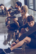 © LIGHTFIELD STUDIOS - group of athletic young people in sportswear sitting on floor and resting at the gym, group fitness concept