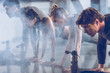 © LIGHTFIELD STUDIOS - group of athletic young people in sportswear doing push ups or plank at the gym, group fitness concept