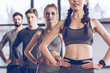 © LIGHTFIELD STUDIOS - Group of athletic young people in sportswear exercising at the gym