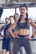 © LIGHTFIELD STUDIOS - Group of athletic young people in sportswear exercising at the gym