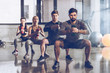 © LIGHTFIELD STUDIOS - Group of athletic young people in sportswear with dumbbells exercising at the gym