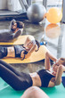 © LIGHTFIELD STUDIOS - Sporty young people doing abs on yoga mats while exercising at the gym