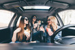 © F8  \ Suport Ukraine - Friendship and time together on road. Three young and beauty women have fun together eating fast food and drive a car in road trip