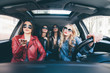 © F8  \ Suport Ukraine - Group of friends having fun whet drive the car. Singing and laughing on the road
