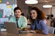 © WavebreakMediaMicro - Smiling creative business people with laptop