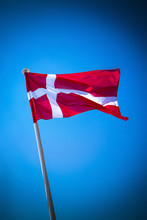 Denmark Flag On Sunny Day Against Clear Blue Sky
