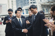 © Jestercine - Asian businessmen handshaking after striking grand dealà¸¡ 30-40 yeal old, vintage tone.