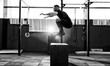 © mirage_studio - Fit young man jumping onto a box as part of exercise routine. Man doing box jump in the gym. Athlete is performing box jumps