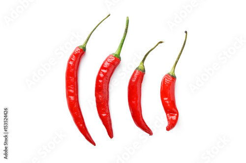 Fotografia  line of hot chili peppers on white background