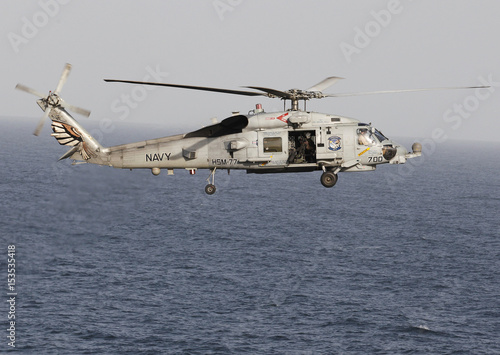 A Sikorsky Sh 60 Seahawk Helicopter Flies Near The Nimitz