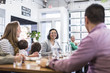 © Cavan Images - Family with children sitting at table in restaurant
