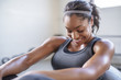 © Cavan Images - Smiling athlete exercising with exercise ball in gym