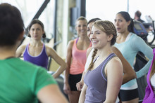 Coach Instructing Women In Gym