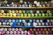 Close-up Of Spray Paints Arranged On Shelves