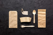 food delivery with paper bags and flatware on dark table background top view mockup