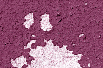 Pink color cracked painted wall pattern.