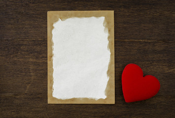 Wall Mural - Blank old paper card and red heart on vintage wood background, valentine card concept