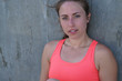 © Marco - Young woman resting on wall after exercising