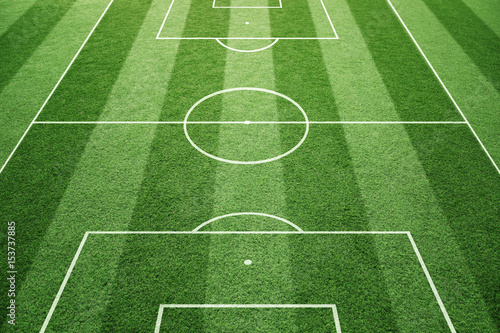 soccer-play-field-ground-lines-on-sunny-grass-pattern-background-goal-side-perspective-used