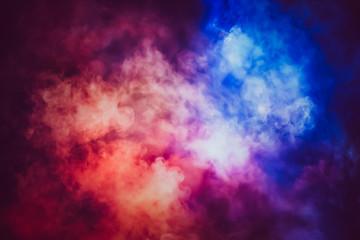 Abstract red and blue lighting mix together in the smoke background.