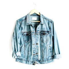 Wall Mural - Beautiful trendy blue denim jeans jacket on hanger near white background. Fashion concept. Flat lay, top view