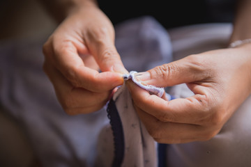 Woman's hand sewing fabric with sewing equipments