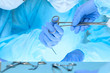 © rogerphoto - Close up of medical team performing operation. Group of surgeons at work in operating theater