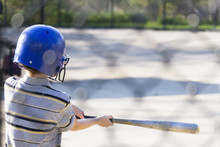 Young Boy Practicing Hitting Baseball At The Batting Cages