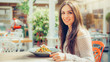 © guruXOX - Young woman enjoying food in a restaurant, having her lunch break