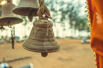 Bell with ornament on the background of trees