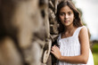 © Erickson Stock - Portrait of girl leaning against stack of firewood