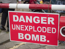 Danger Unexploded Bomb Sign At A Wartime Reenactment Event In The UK.