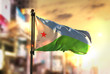 Djibouti Flag Against City Blurred Background At Sunrise Backlight