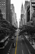 Endless streets of Manhattan New York skyscraper cars yellow lane marking black and white