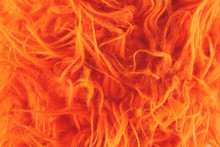 Yellow Fur Texture Background. Synthetic Orange Fur Is Made To Protect Nature And Protest Against The Killing Of Animals. Close-up Of Artificial Wool