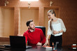 © nagaets - Confident boss with paper explaining something to secretary in the office