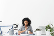 © wayhome.studio  - Fashionable female Afro American student doing her homework designing new buildings sitting in cosy home interior drinking coffee holding pen and having thoughtful expression. People and education