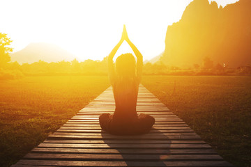 Fotobehang - Serenity and yoga practicing at sunset, meditation
