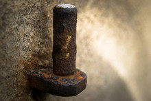 Closeup Of Old Rusty Door Hinge On Stone Background