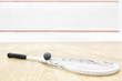 one squash racket and ball