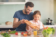 © Friends Stock - Young father and daughter cooking meal together