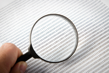 a black and white image of a human scrutinizing software code, this image can be used to represent t