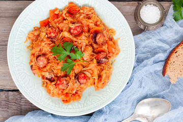 Wall Mural - Stewed cabbage with sausages, German cuisine, horizontal, top view