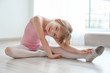 © Africa Studio - Cute little ballerina sitting on floor in dance studio