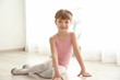 © Africa Studio - Cute little ballerina sitting on floor in dance studio