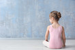 © Africa Studio - Cute little ballerina sitting on floor in dance studio