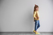 © Africa Studio - Little fashion girl standing in light room