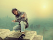 Hip hop performer posing, cityscape on background
